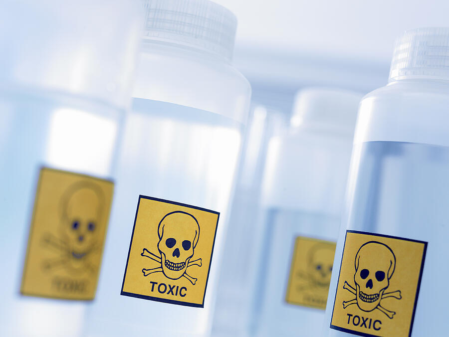 Bottles with toxic labels Photograph by Adam Gault