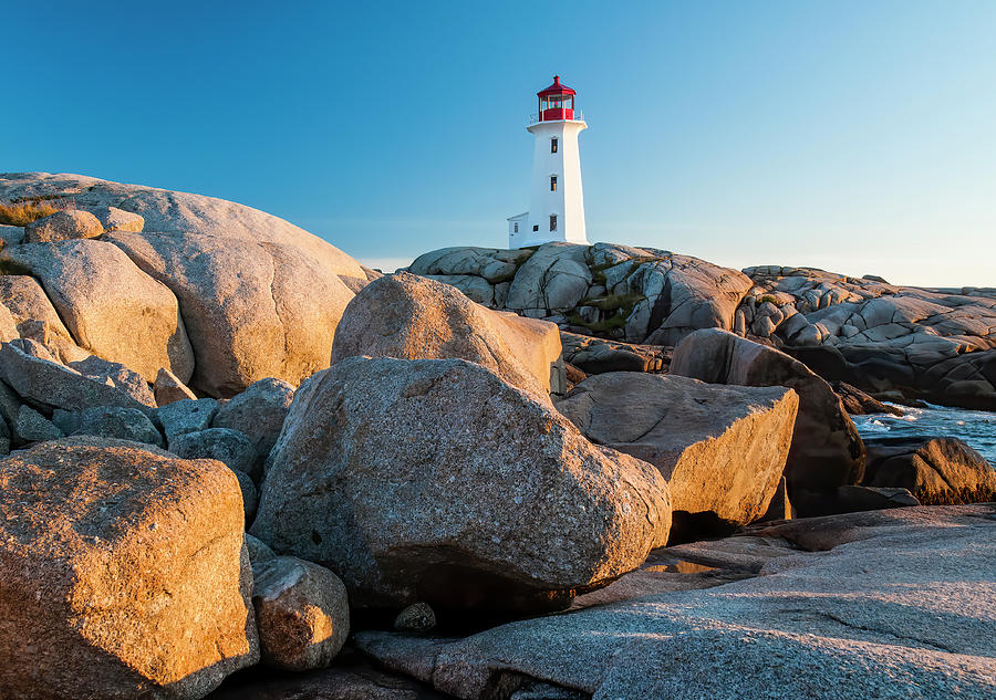 Boulders and Peggys Cove Lighthouse Photograph by Ginger Stein