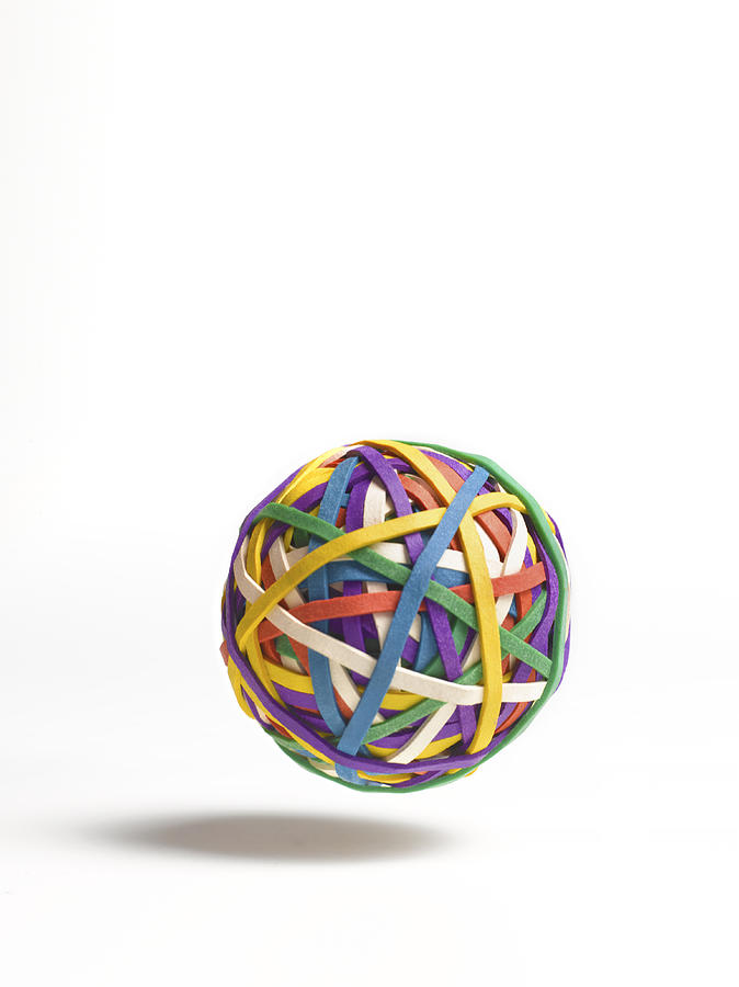 Bouncing ball of elastic bands Photograph by Peter Dazeley