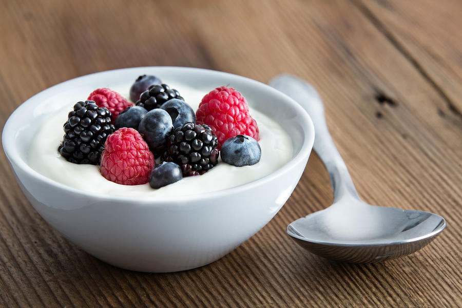 Bowl of fresh mixed berries and yogurt Photograph by Ozgurcoskun