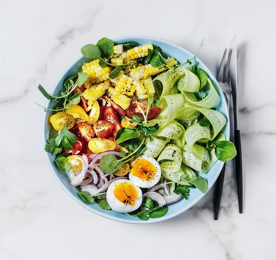 Bowl of fresh salad with boiled eggs on white background Photograph by Claudia Totir