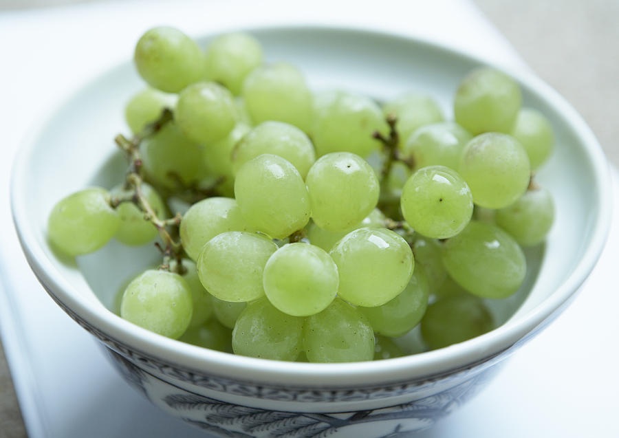 Bowl of green grapes, close-up Photograph by Heidi Coppock-Beard