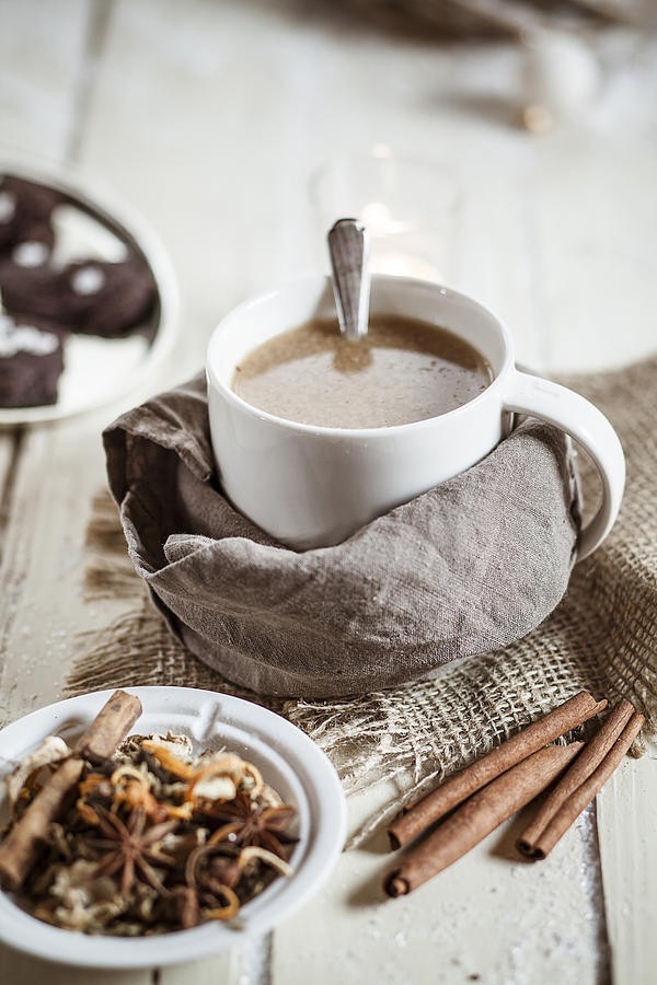 Bowl of Masala chai with almond milk on jute and wood Photograph by Westend61