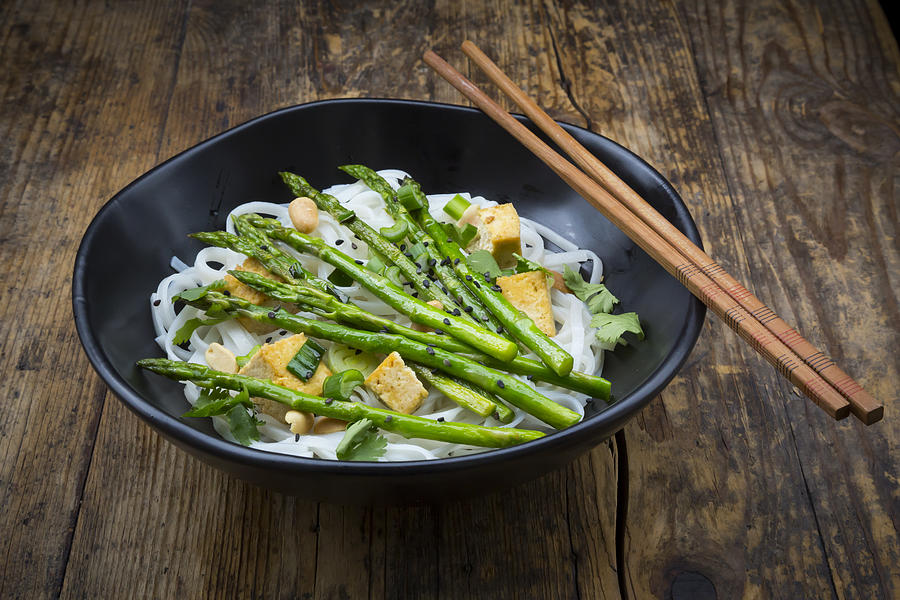 bowl of vegan Pad thai with mini green asparagus and tofu Photograph by Larissa Veronesi