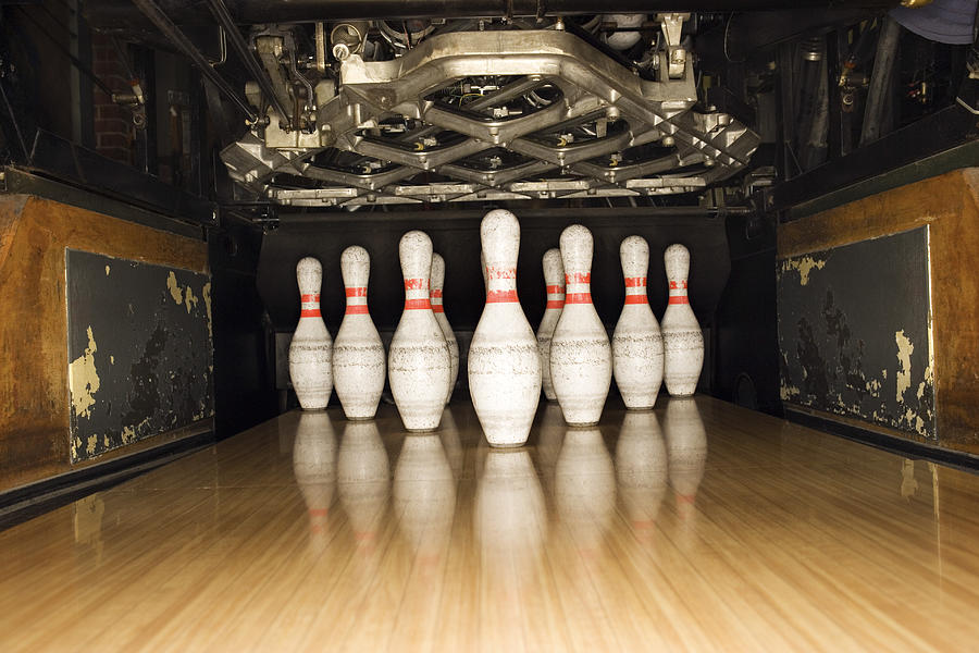 Bowling pins and machine Photograph by Thinkstock