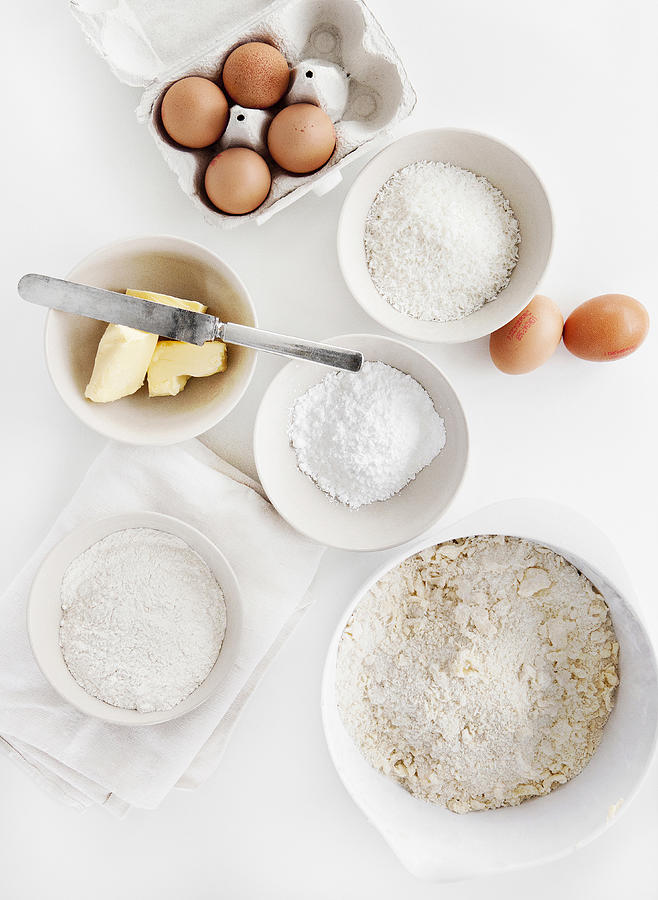Bowls of sugar, flour, eggs, butter Photograph by Line Klein