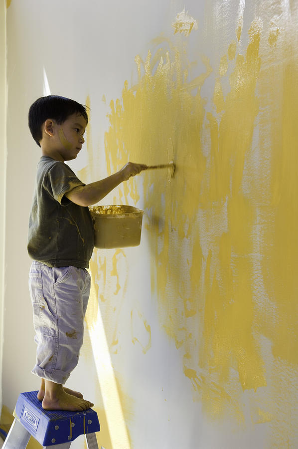 Boy (2-4) painting wall, side view Photograph by Zia Soleil