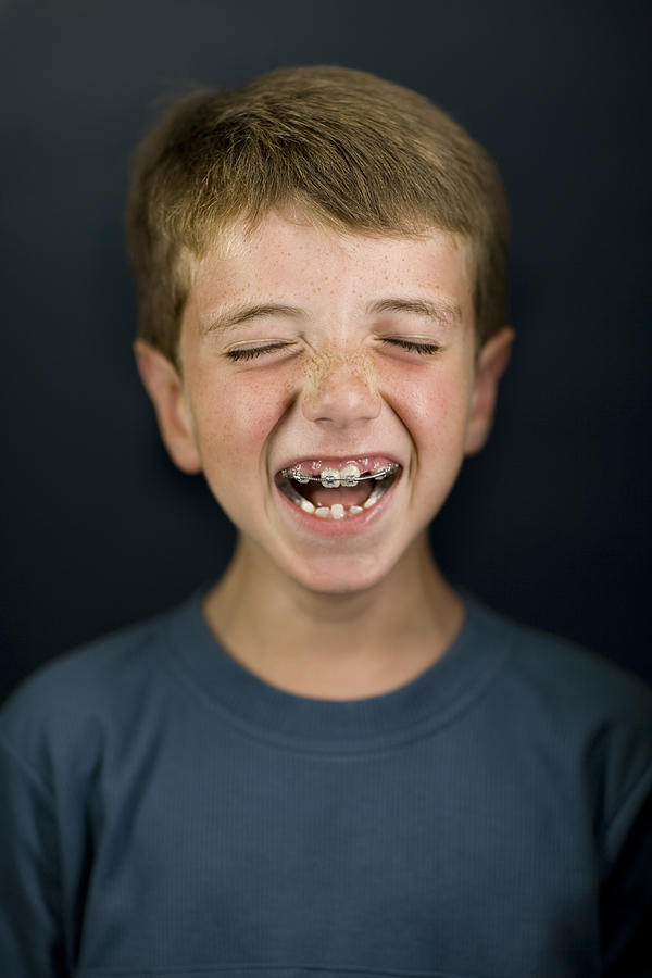 Boy (6-7) laughing, eyes closed, close-up Photograph by David Sacks