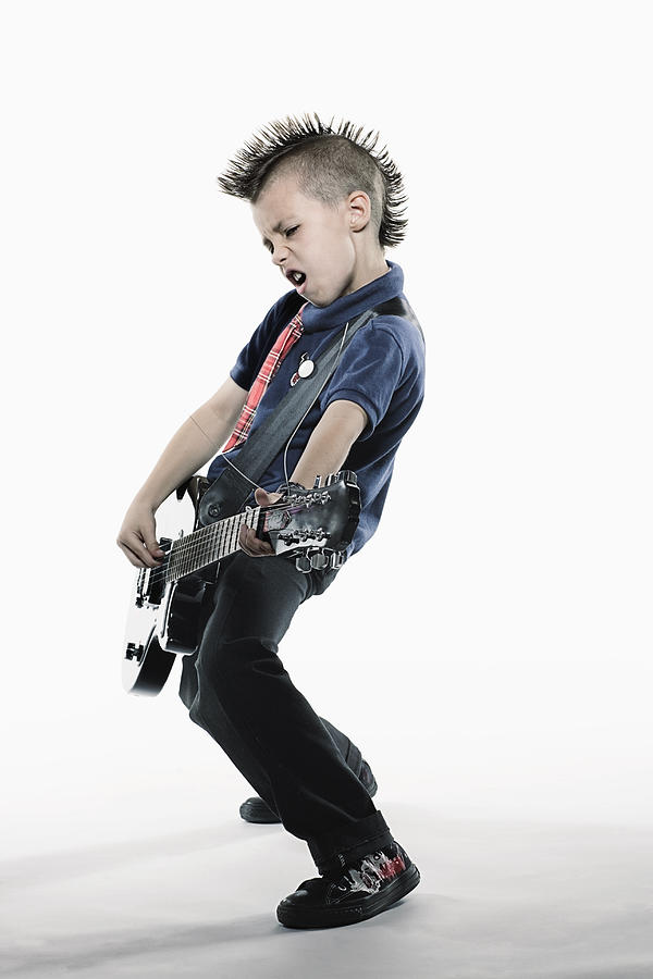 Boy (8-10) playing guitar Photograph by Siri Stafford