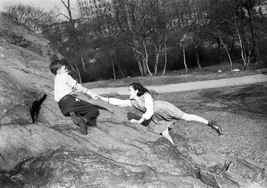 Boy and girl (10-11) playing in park Photograph by George Marks