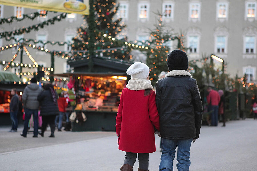 Boy and girl walking hand in hand at the christmas market Photograph by Susan.k.