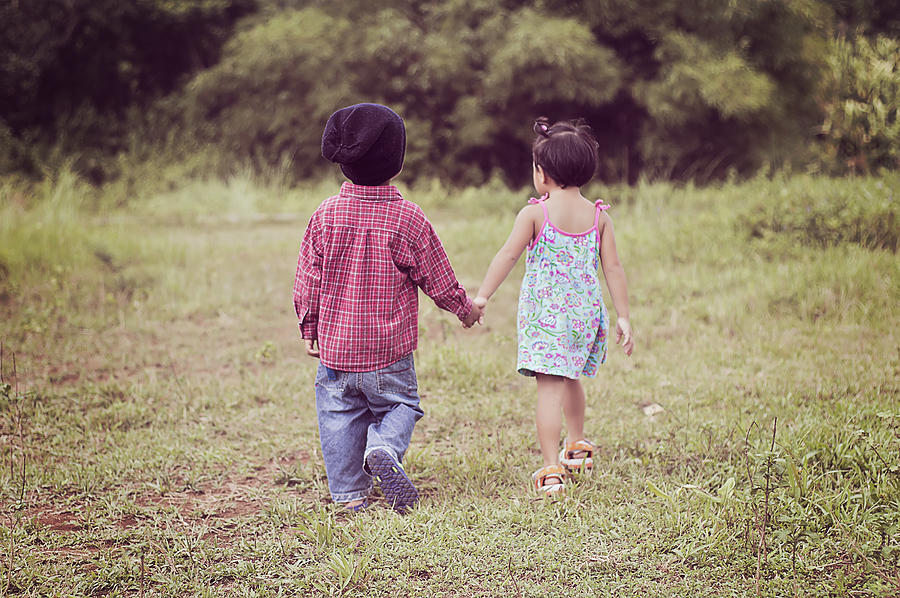 Boy and girl walking hand in hand Photograph by Gilbert Rondilla Photography