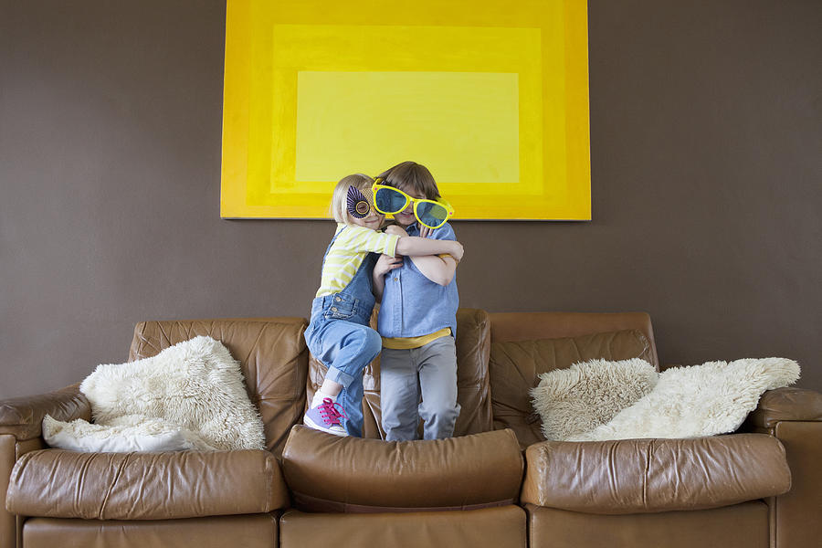 Boy and girl wearing oversized sunglasses and mask Photograph by Compassionate Eye Foundation/Natasha Alipour Faridani