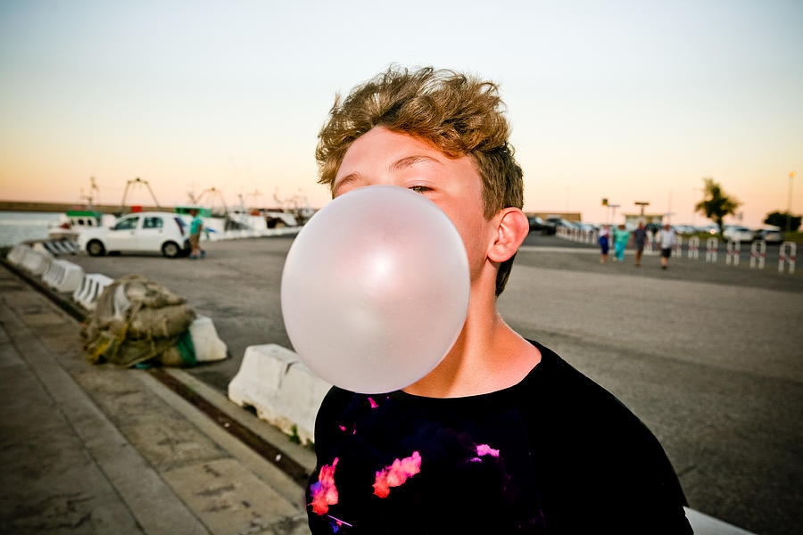 Boy blowing a bubble Photograph by Dave G Kelly