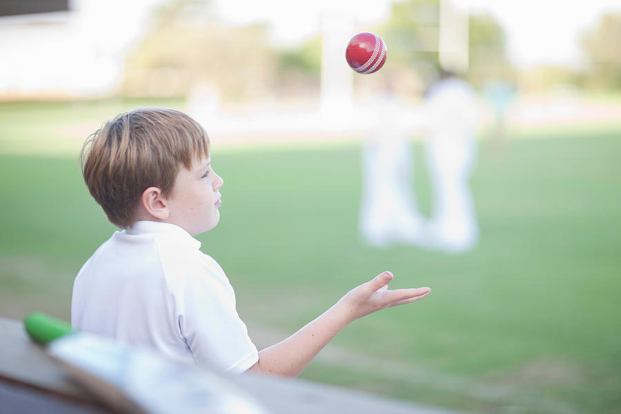 Boy catching cricket ball Photograph by Zero Creatives