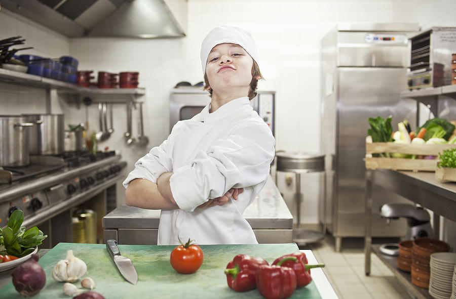 Boy chef with vegetables in kitchen Photograph by Cultura RM Exclusive/Luc Beziat