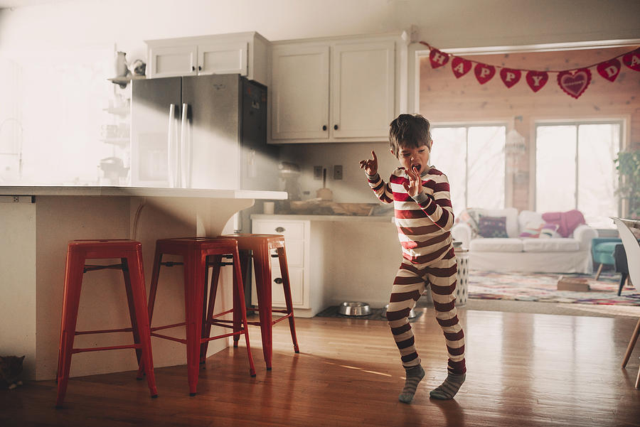 Boy dancing in the kitchen in his pyjamas Photograph by Elizabethsalleebauer