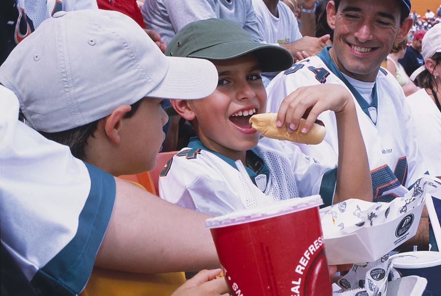 Boy Eating Hot Dog in Stadium Photograph by Juan Silva