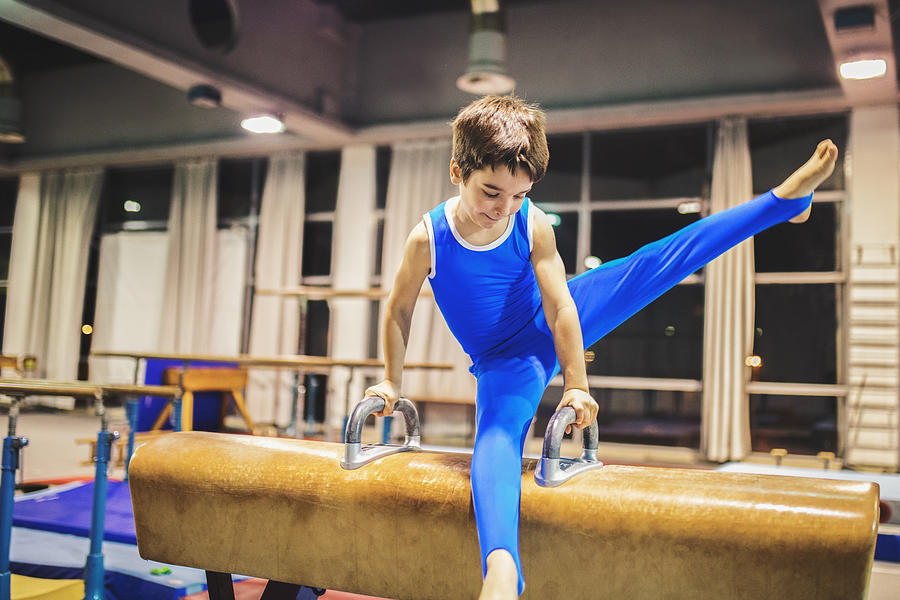Boy exercising on pommel horse. Photograph by M_a_y_a