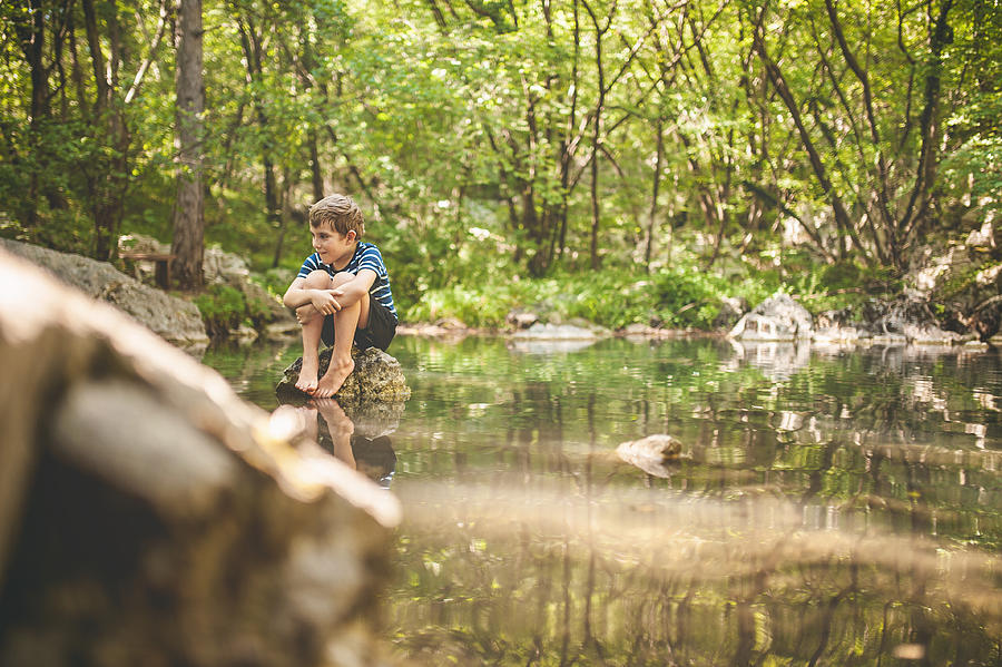 Boy Having An Adventure By Walking In The Lake Admiring  A  Beautiful Scenic Forest Photograph by Pankration