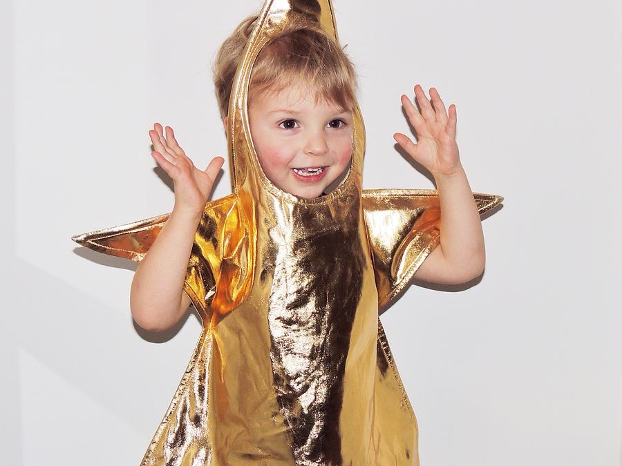 Boy in fancy dress gold star costume Photograph by Hannahargyle