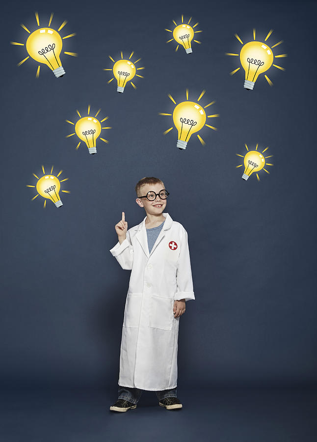 Boy in lab coat with cartoon lightbulbs Photograph by Flashpop