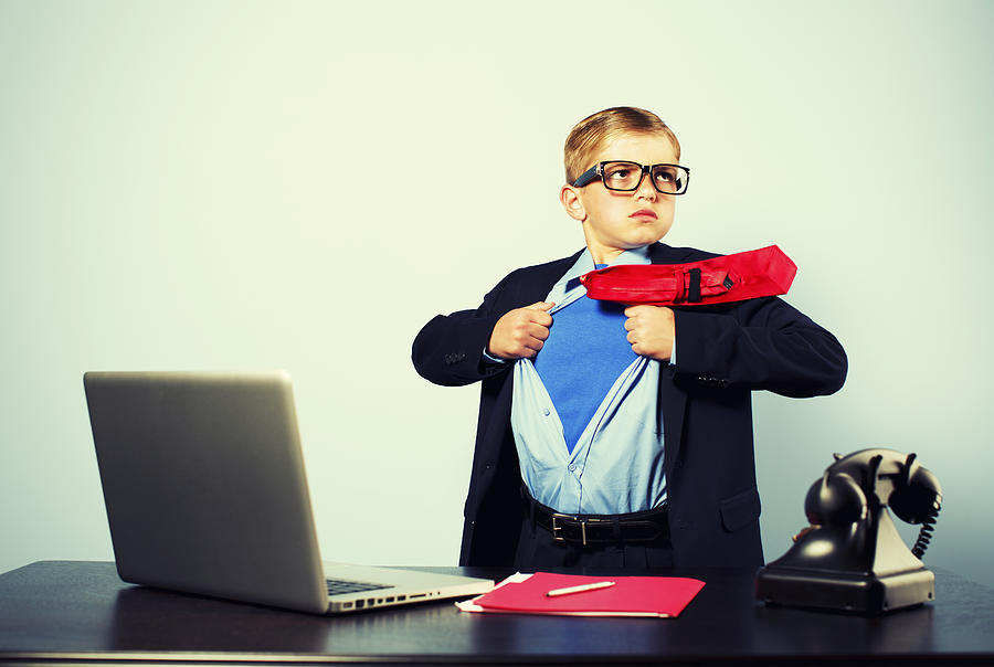 Boy in Office Dressed as Superhero at Laptop Photograph by RichVintage