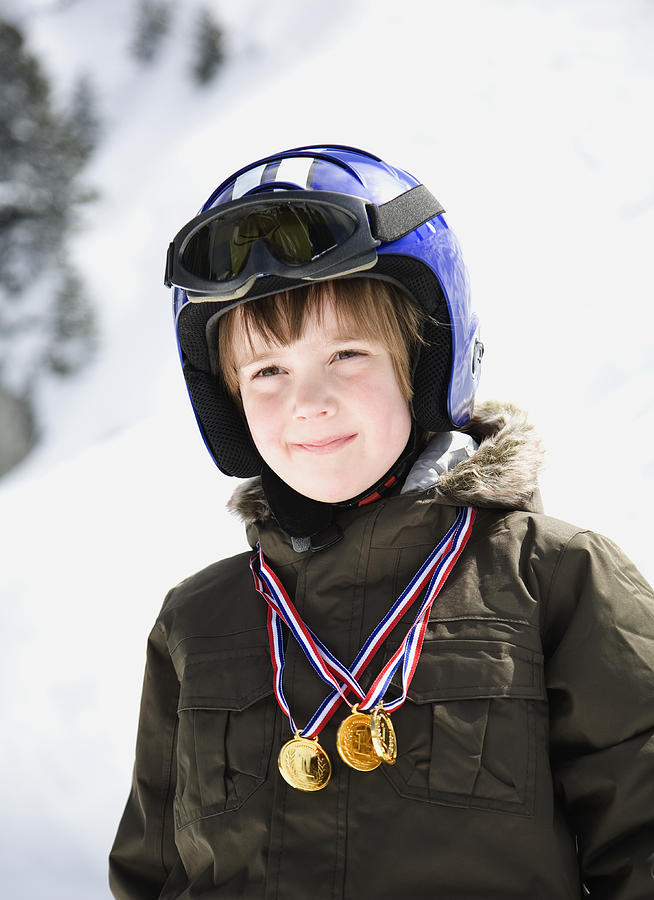 Boy in ski gear with winner medals  Photograph by Ashley Jouhar
