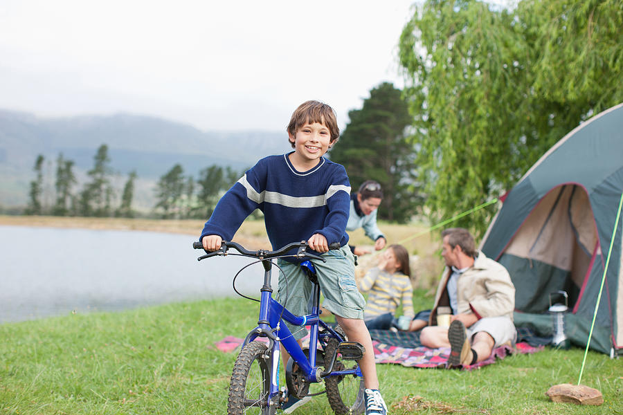 Boy on bicycle while on family camping trip Photograph by Paul Bradbury