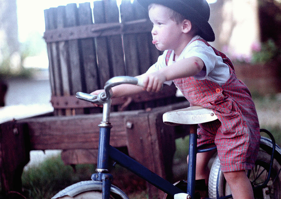 Boy on bike Photograph by Corinne Malet