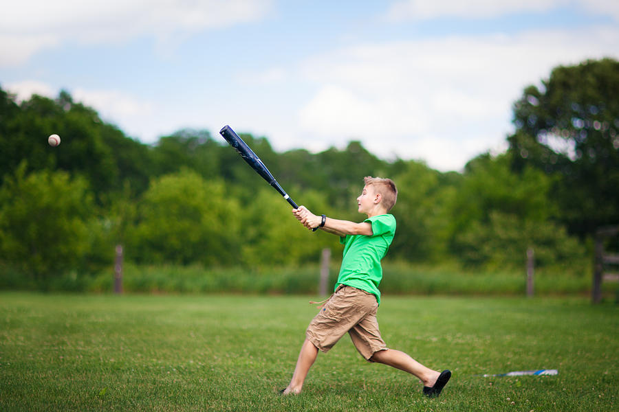 Boy playing baseball on field Photograph by Rebecca Nelson