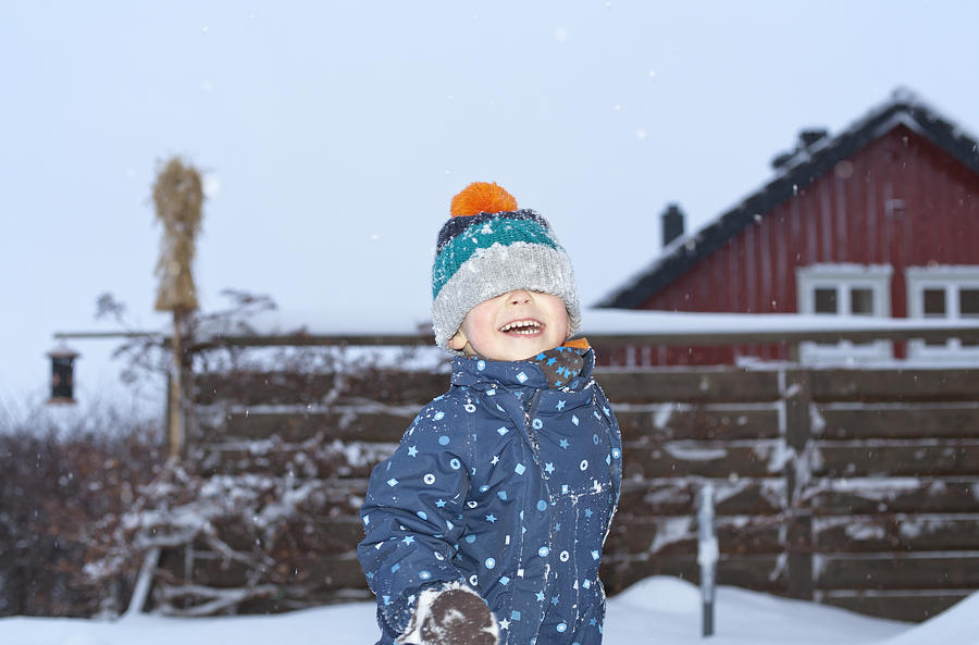 Boy playing in the snow Photograph by Tiina & Geir