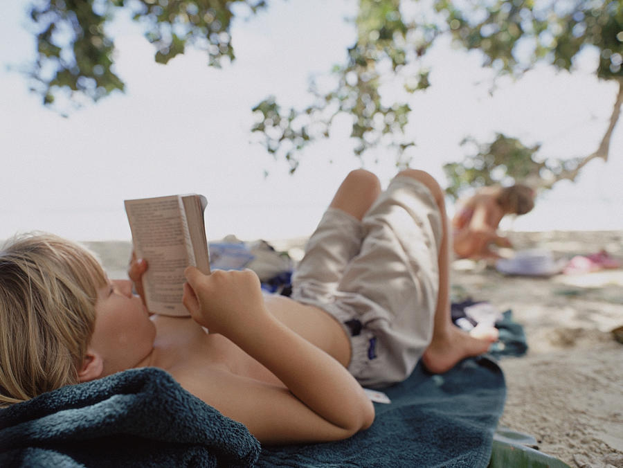 Boy reading book Photograph by Ascent/PKS Media Inc.