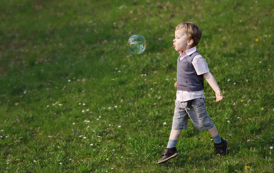 Boy runs after a big soap bubble Photograph by Tatjana Kaufmann