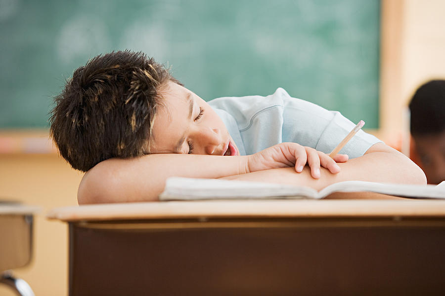 Boy sleeping on desk Photograph by Image_Source_