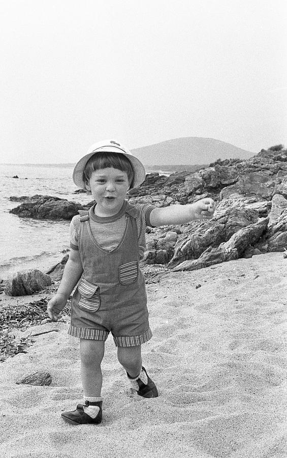 Boy walking on beach Photograph by Rosmarie Wirz