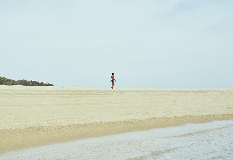 Boy walking the beach Photograph by Yosuke Suzuki