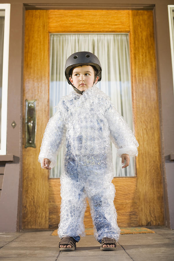 Boy wearing bubble wrap and helmet Photograph by Jupiterimages