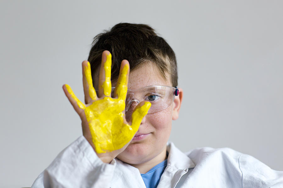 Boy with yellow paint on hand Photograph by Gombert, Sigrid/science Photo Library