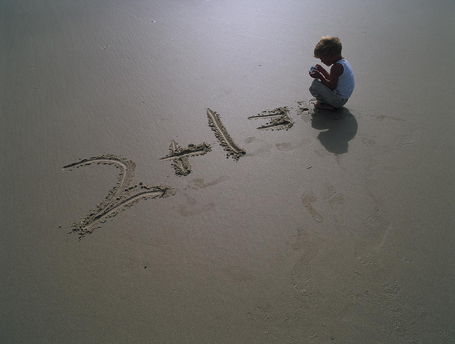Boy Writes Sum in Sand Photograph by David Trood