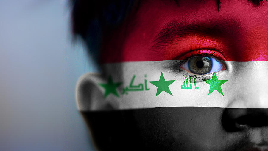 Boys face, looking at camera, cropped view with digitally placed Iraq flag on his face. Photograph by Mariano Sayno