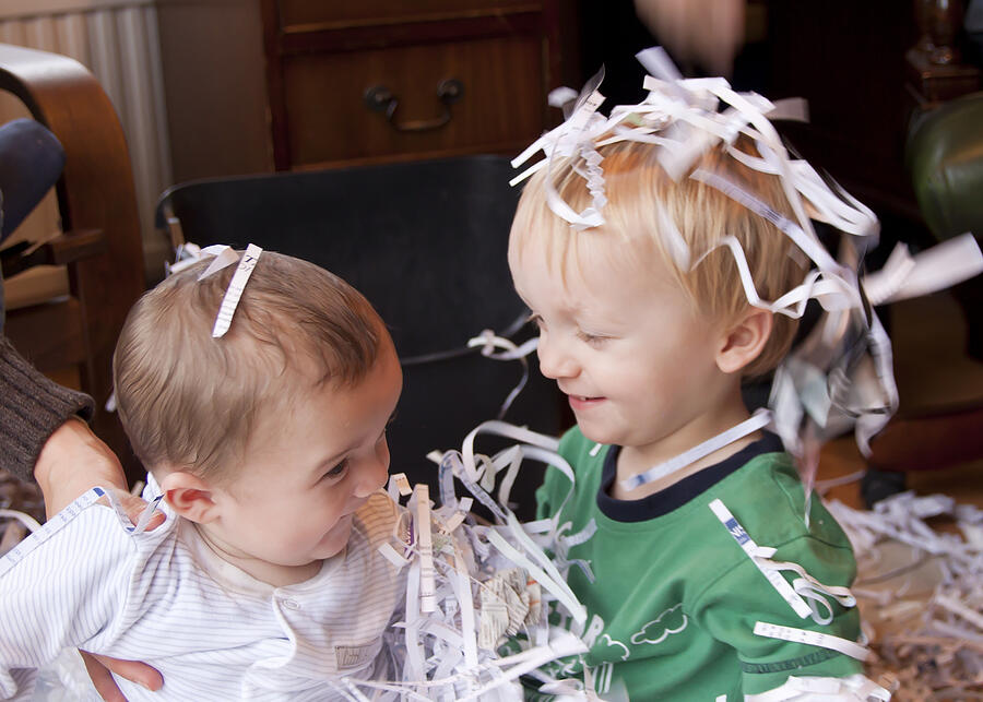 Boys playing with shredded paper Photograph by Michael Honor