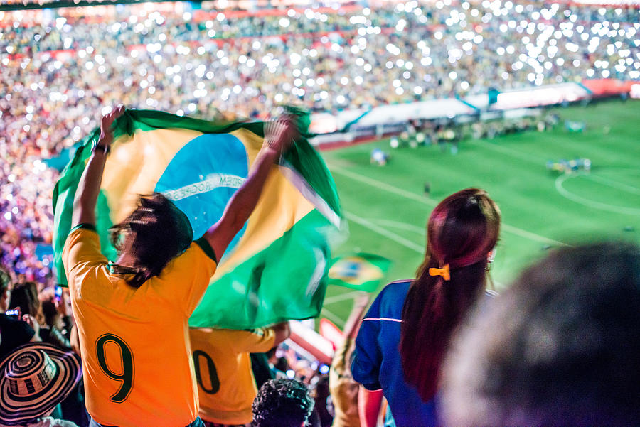 Brazilian fun in soccer game with flag Photograph by Ramiro Olaciregui