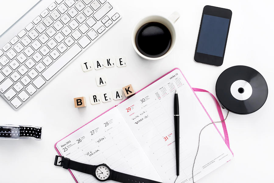 Break concept with open planner, keyboard, cup of coffee, phone lying on desk Photograph by Johner Images