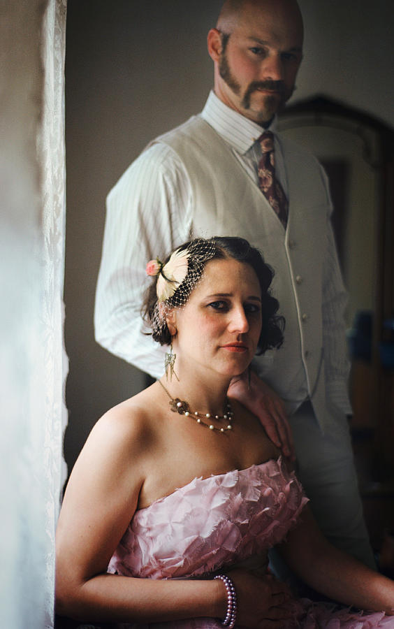 Bride and groom posing at window Photograph by Danielle D. Hughson