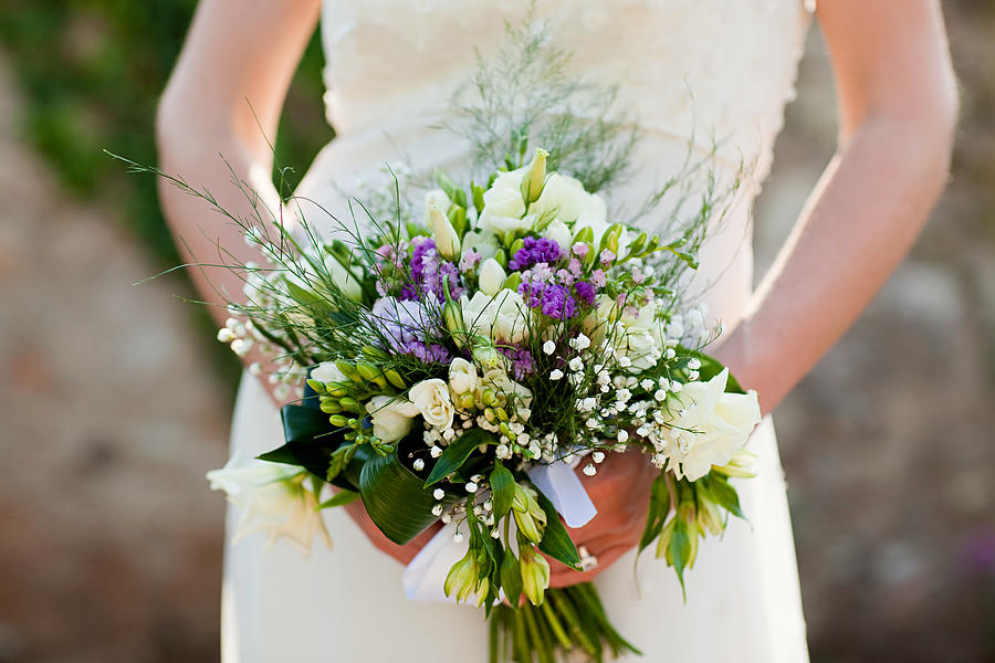 Bride holding bouquet, close up Photograph by Image Source