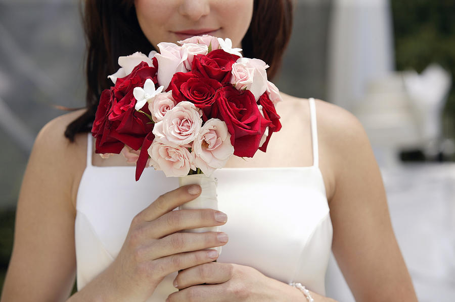 Bride holding bouquet Photograph by Comstock Images
