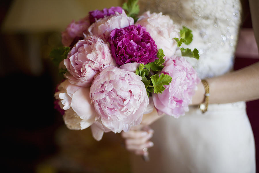 Bride holding bouquet of peony flowers Photograph by Elisa Cicinelli