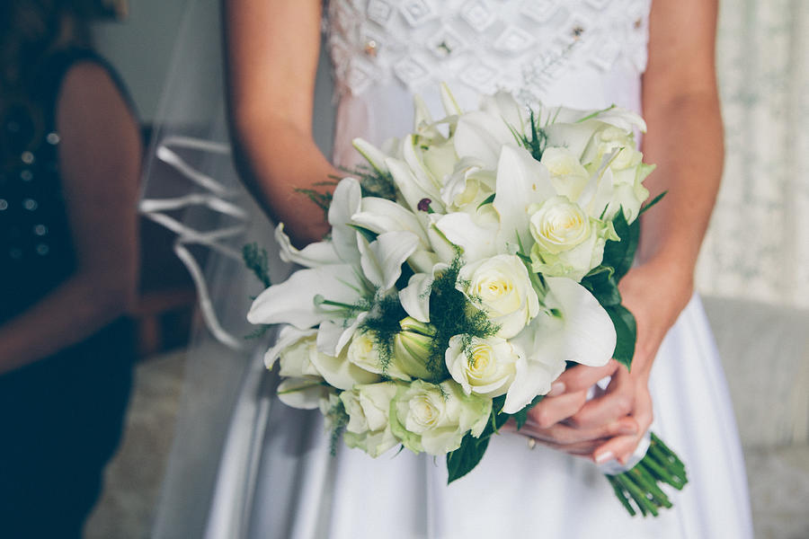 Bride holding bouquet of white flowers Photograph by Jodie Griggs