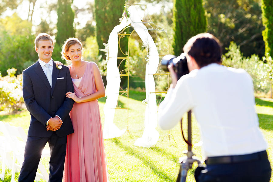 Bridesmaid And Best Man Posing For Photographer Photograph by Neustockimages